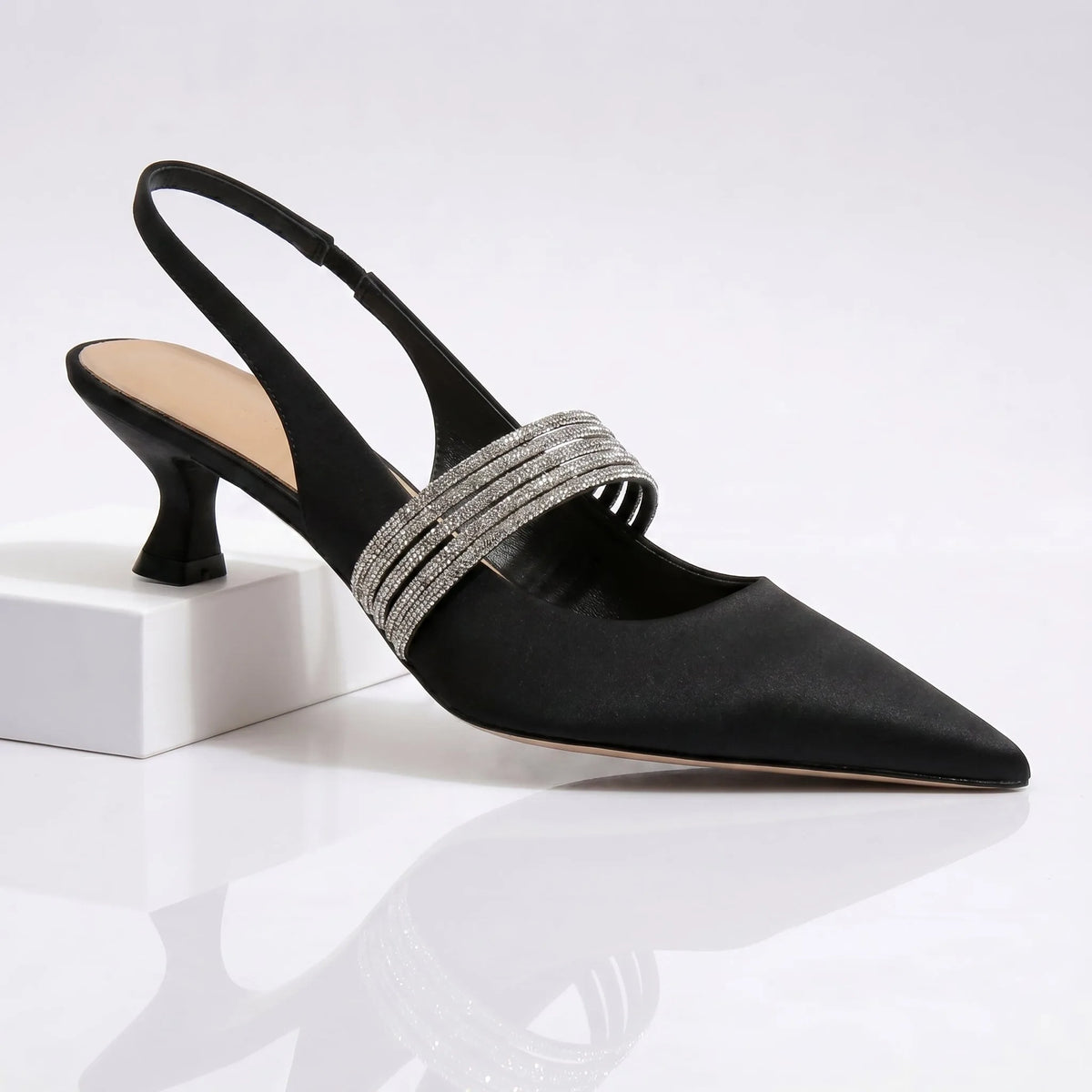 Front angle of champagne kitten heels highlighting slingback strap and sculpted heel shape