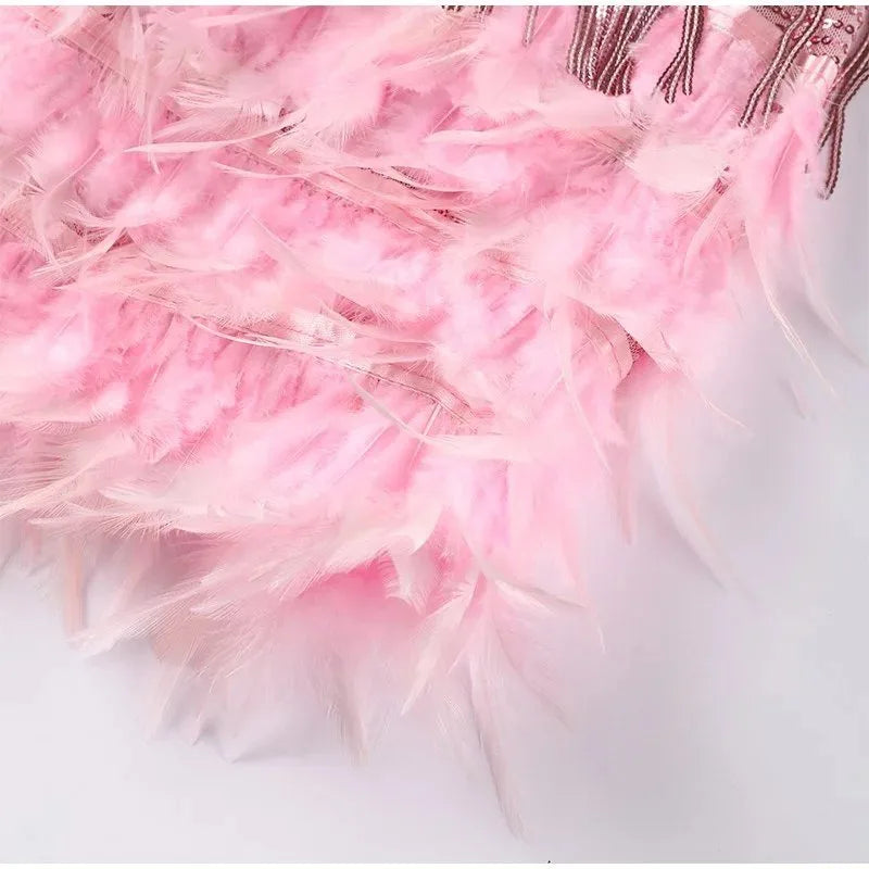 Back view of the fringe mini dress highlighting the thin crossed straps and open back design