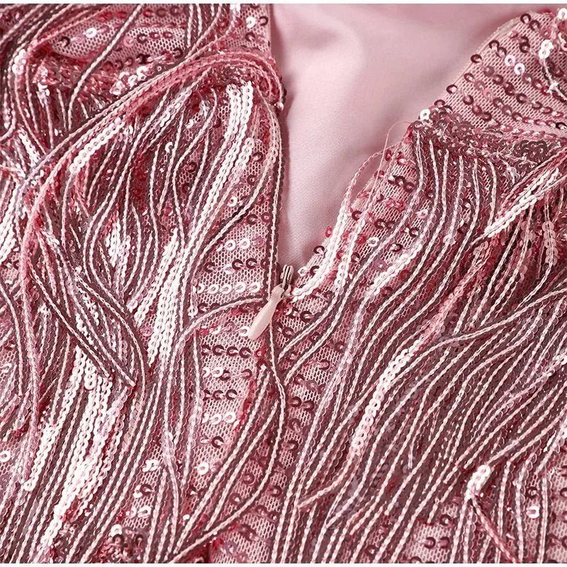Detail shot of the feather hem trim at the bottom of the fringe mini dress