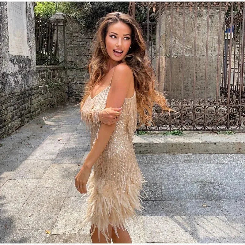 Side angle of the fringe mini dress highlighting the body-skimming fit through the waist and hips