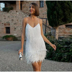 Close-up front view of the white sequin fringe mini dress showing the feathered hem and spaghetti straps