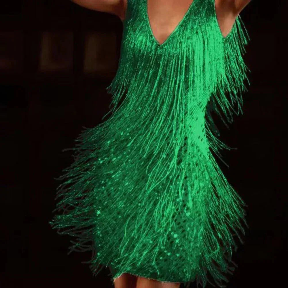 Close-up of emerald green sequin fringe mini dress highlighting the tiered fringe texture and glossy sequins