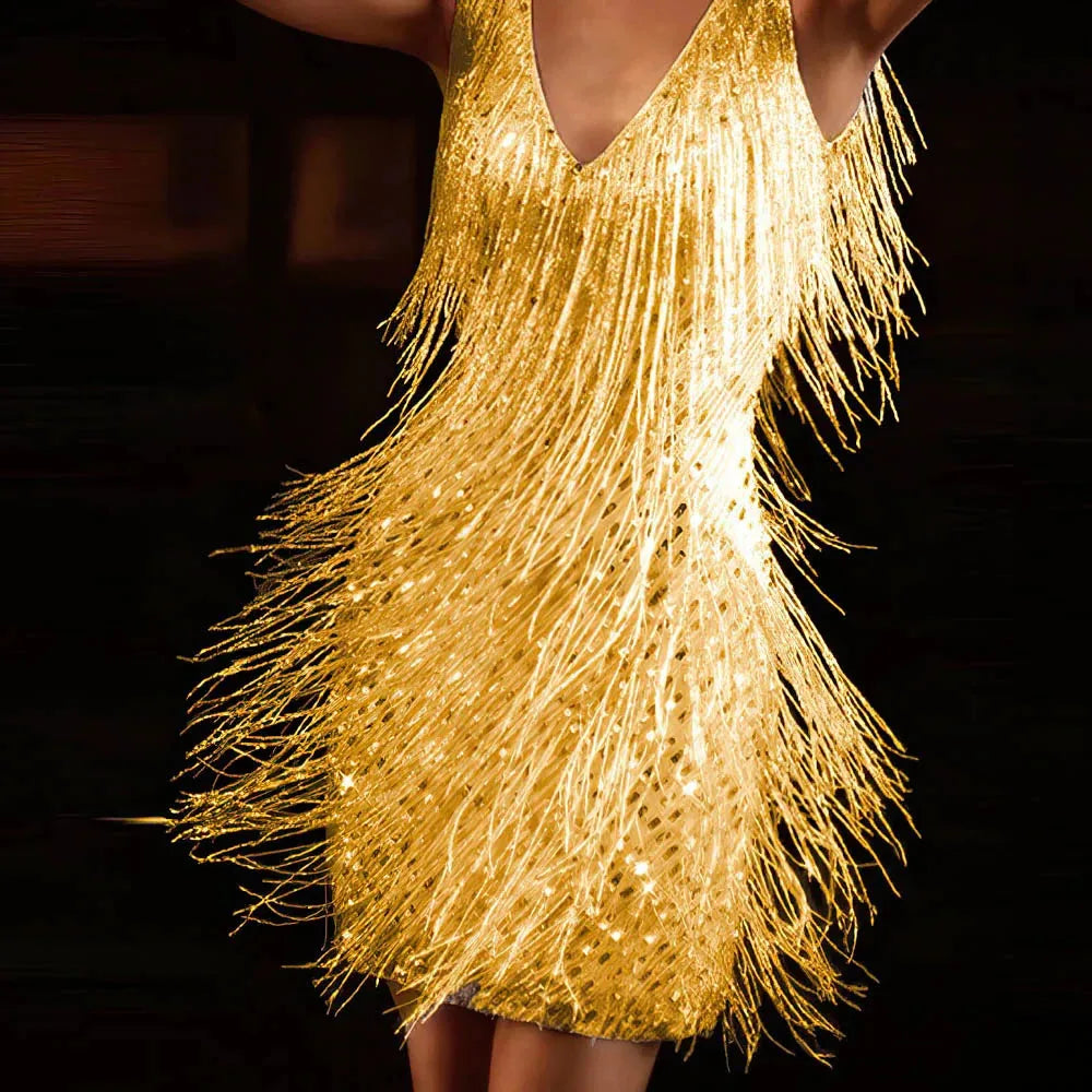 Front view of the gold sequin fringe mini dress paired with strappy metallic heels for an evening look