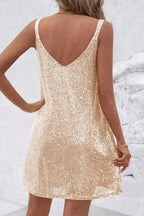 Back view of the light gold sequin mini dress highlighting the sequin straps and open V-back