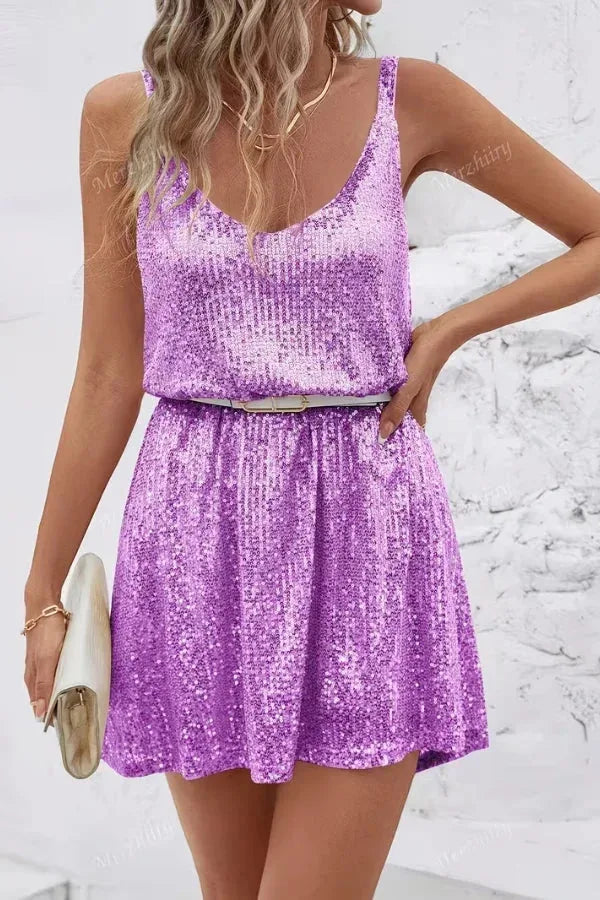 Front view of a purple sequin mini dress cinched at the waist with a belt, paired with a clutch bag