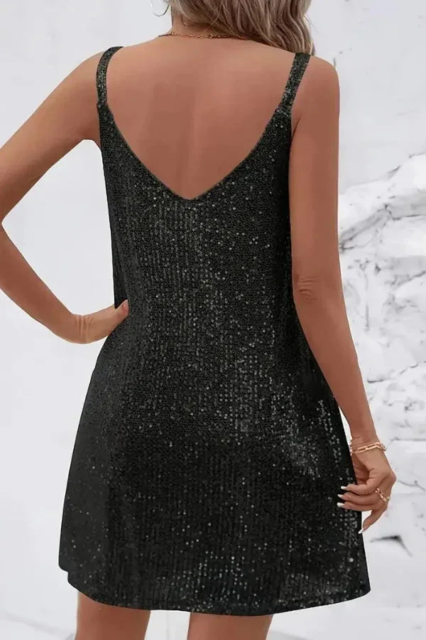 Close-up of the sequin fabric texture on a mini dress showing the dense all-over sequin embellishment