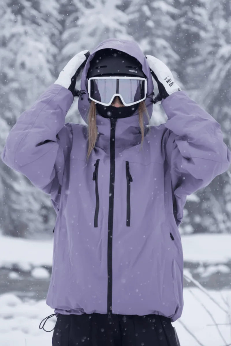 Close-up of the lilac purple jacket with hood pulled over a helmet, hands adjusting the drawcord toggles