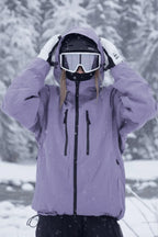 Close-up of the lilac purple jacket with hood pulled over a helmet, hands adjusting the drawcord toggles