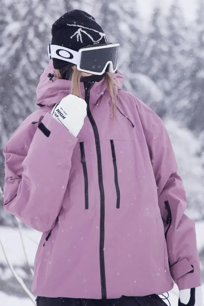 Back and side close-up of the dusky pink jacket showing the hood, zip pocket and sleeve tab detailing