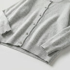 Navy blue cardigan displayed flat showing overall silhouette with crew neck and six-button closure