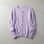 Lilac purple cardigan laid flat displaying soft knit fabric and ribbed trims on a light stone surface