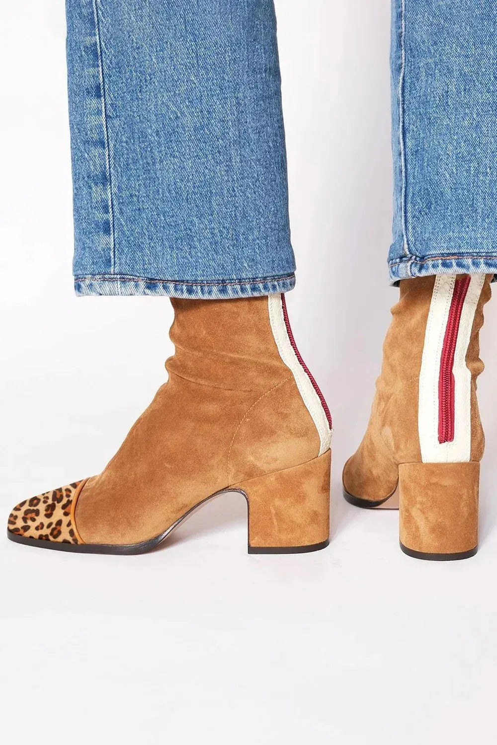 Side and back view of camel suede ankle boot with leopard-print toe cap and striped heel panel