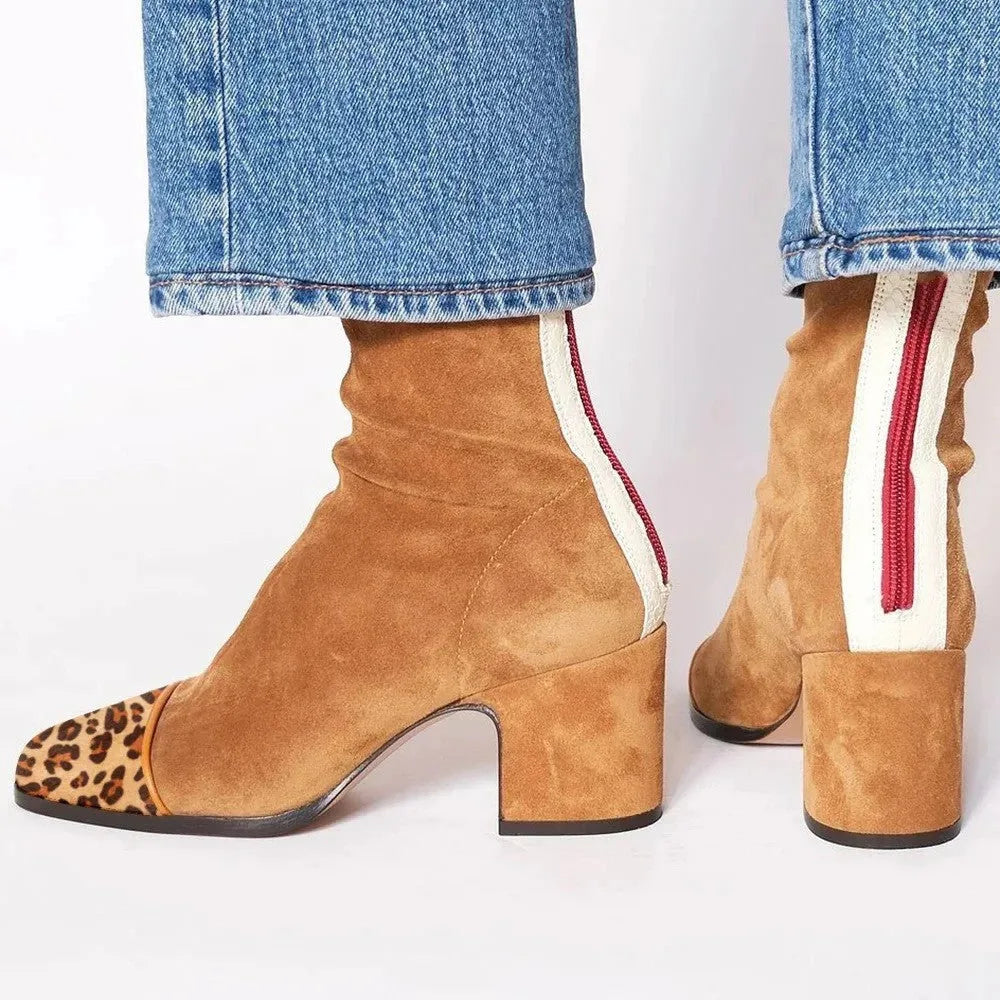 Front view of red suede ankle boots with square toe and contrast heel tab