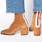 Front view of red suede ankle boots with square toe and contrast heel tab