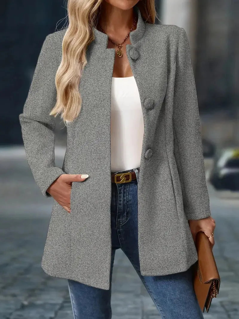 Grey marl stand-collar coat with covered buttons, worn open with a white top and jeans