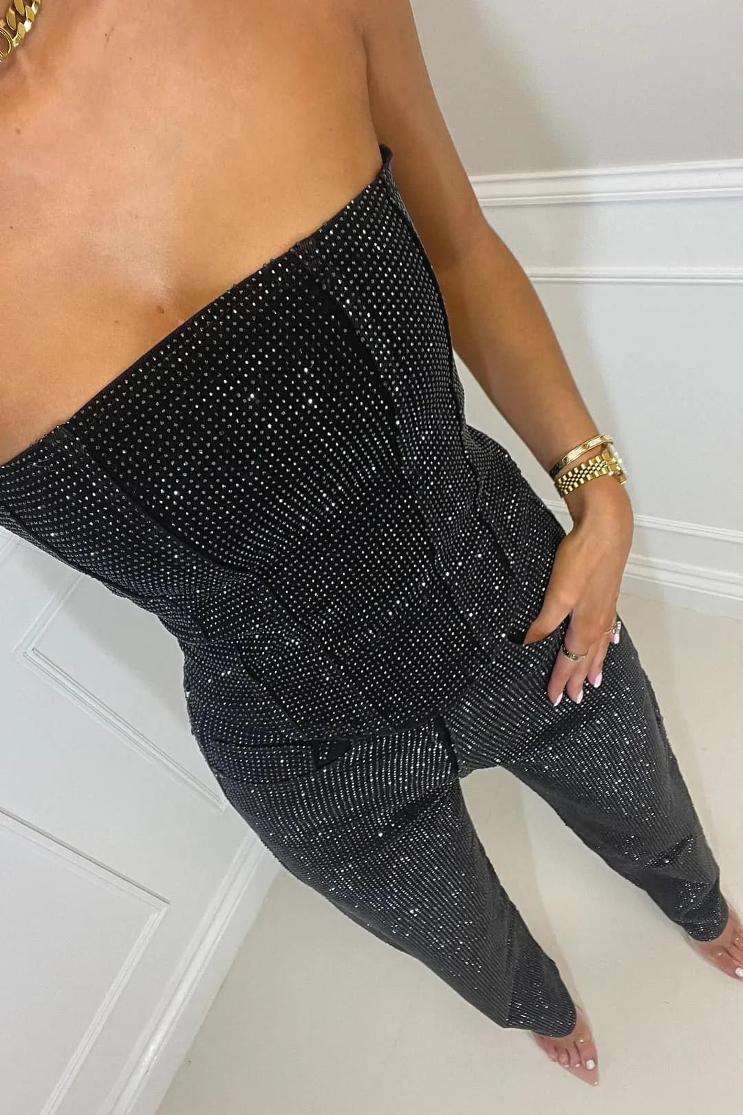 Close-up of the textured sequin fabric on the strapless bodice and trouser waistband, showing reflective detailing