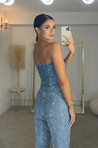 Back view of the strapless sequin denim jumpsuit showing the back seaming, rear pocket detail and straight-leg fit