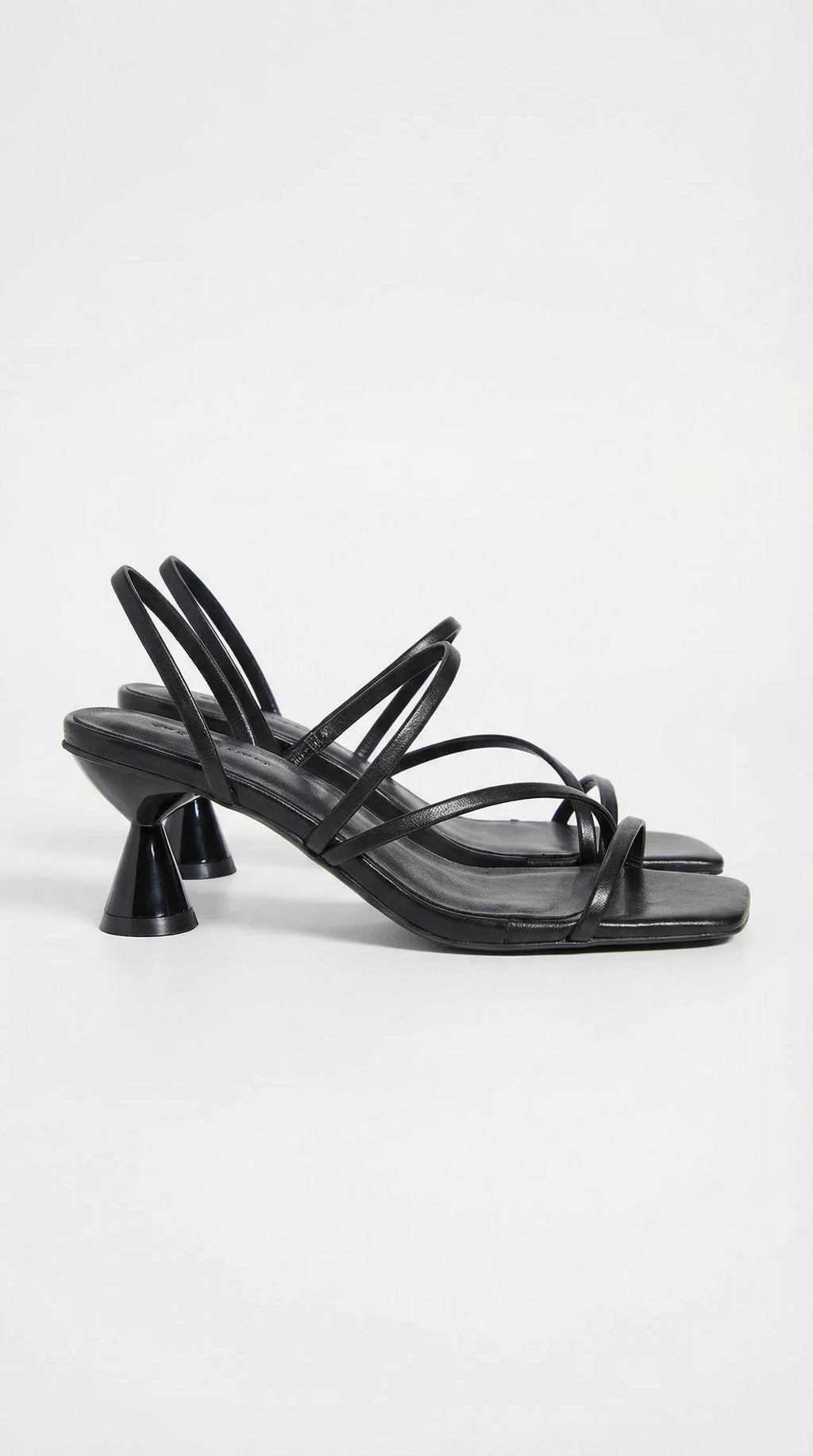 Side view of black strappy heeled sandal with square toe and sculpted heel