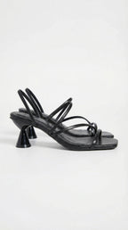 Side view of black strappy heeled sandal with square toe and sculpted heel
