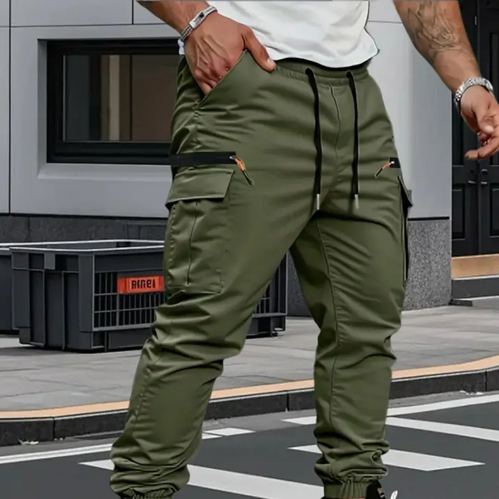 Rear view of green cargo trousers with drawstring waist, zip side pocket and elastic ankle cuff