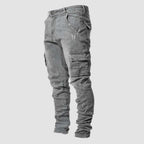 Grey washed denim cargo jeans shown from the side, highlighting the tapered leg and stitched flap pocket.