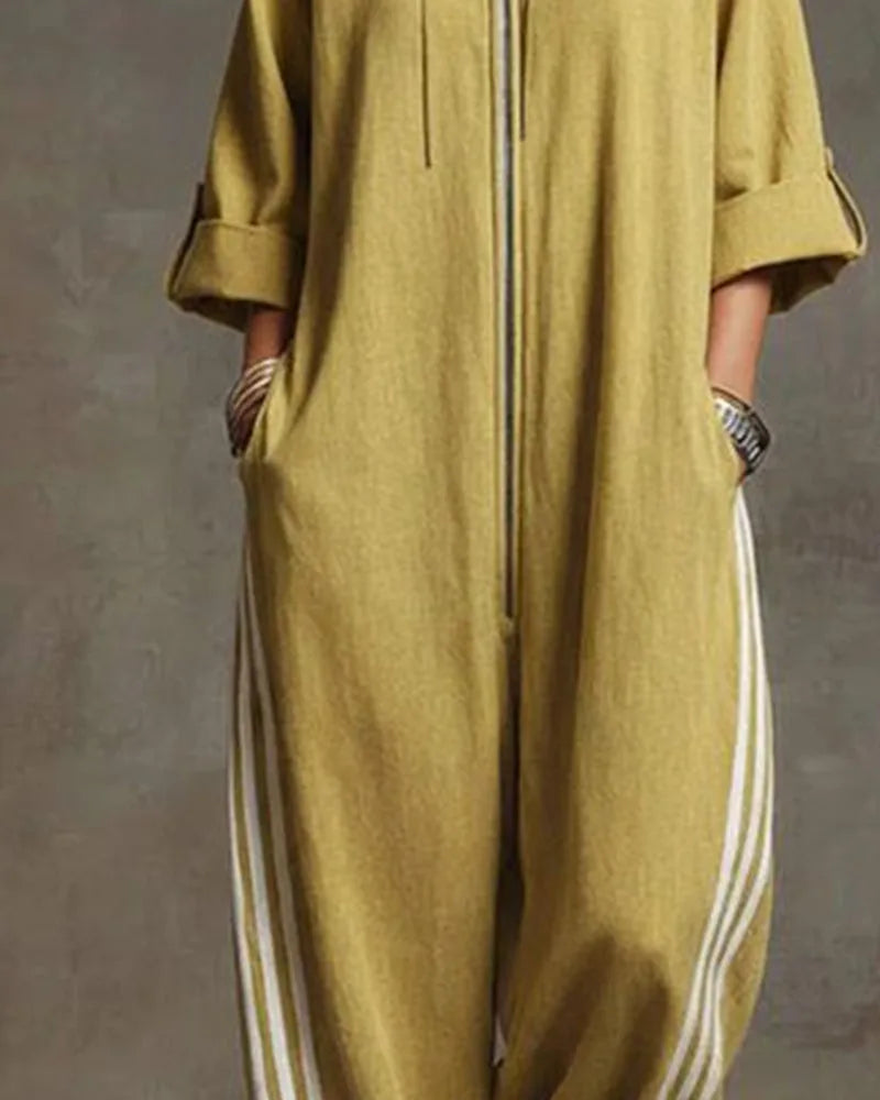 Close-up of the zip, drawstring and rolled sleeve cuff on a mustard yellow oversized jumpsuit