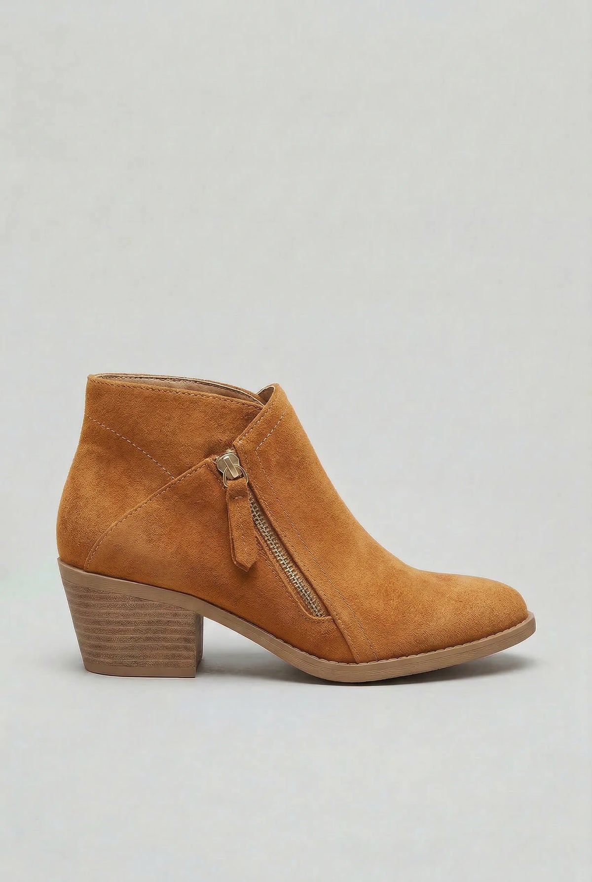 Side profile of a tan suede ankle boot with gold-tone zip and wooden-look block heel