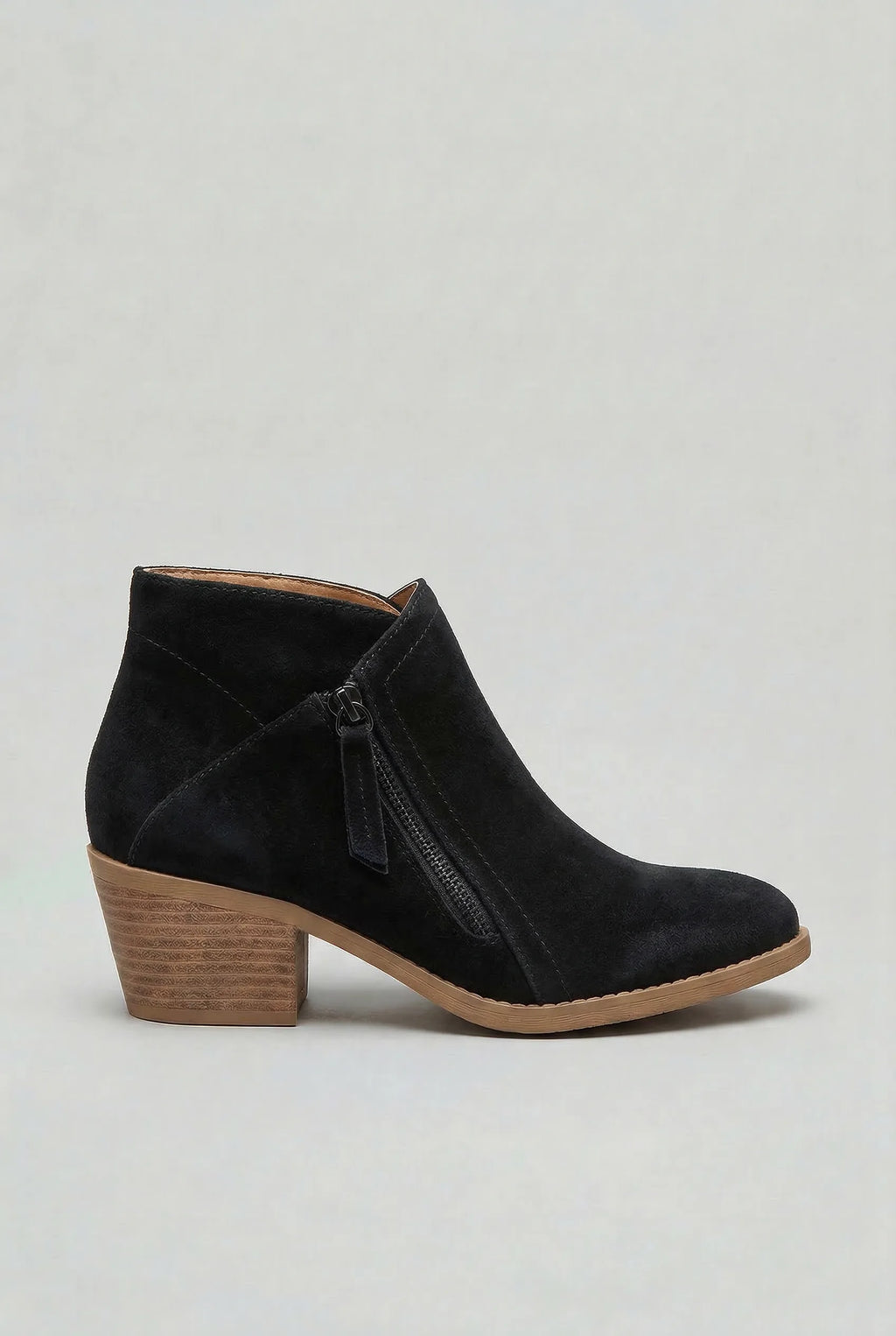 Side profile of a black suede ankle boot with a dark side zip and stacked block heel