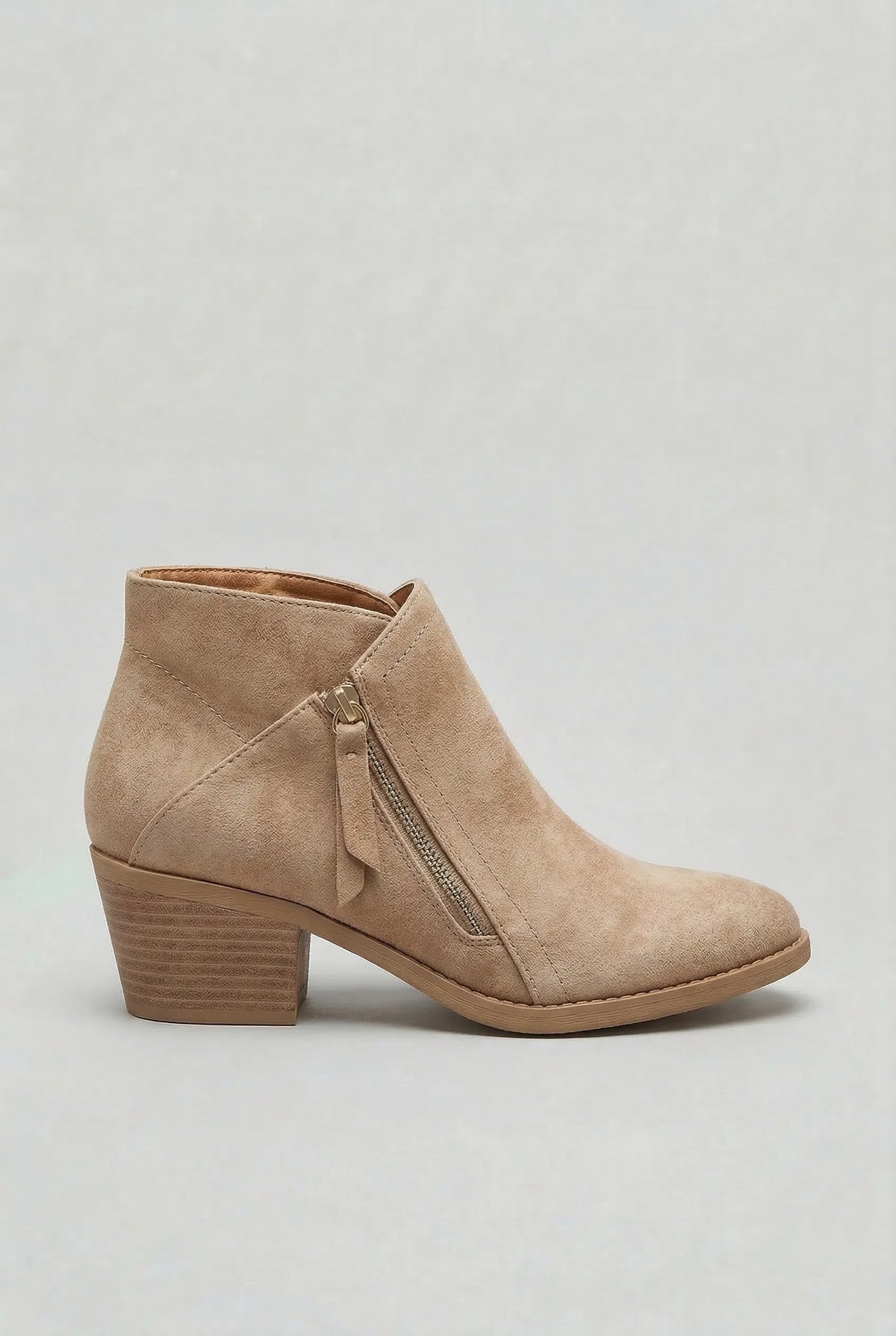 Side profile of a beige suede ankle boot with a gold-tone zip and block heel