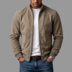 Front view of the khaki suede jacket unzipped, showing ribbed cuffs and hem detail