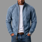 Blue suede jacket with stand collar shown unzipped, paired with a white tee and denim