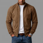 Brown suede jacket worn casually open, showing the shoulder seam and front zip