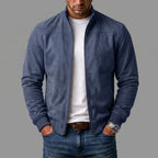 Navy blue suede bomber jacket unzipped, close-up of ribbed cuffs and front pockets