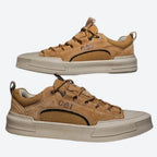 Side view pair of tan brown suede low-top trainers with contrast stitching and cream toe cap