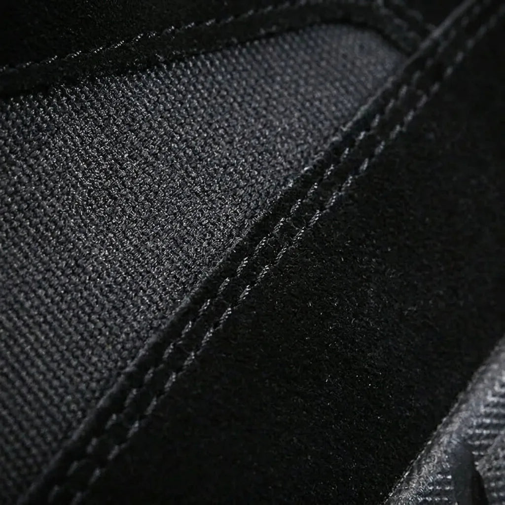 Close-up of black canvas and suede stitching detail on the boot's upper construction