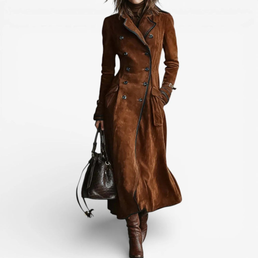Front view of a woman wearing a caramel brown suede double-breasted trench coat with a black bag