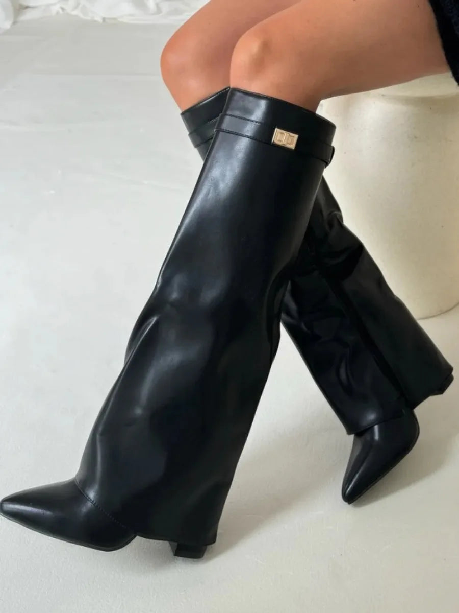 Close-up of dark brown suede boot cuff with gold turn-lock buckle and stitched fold panel