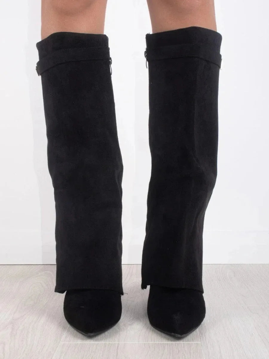 Front view of both legs wearing black suede fold-over boots showing the pointed toes and side zip