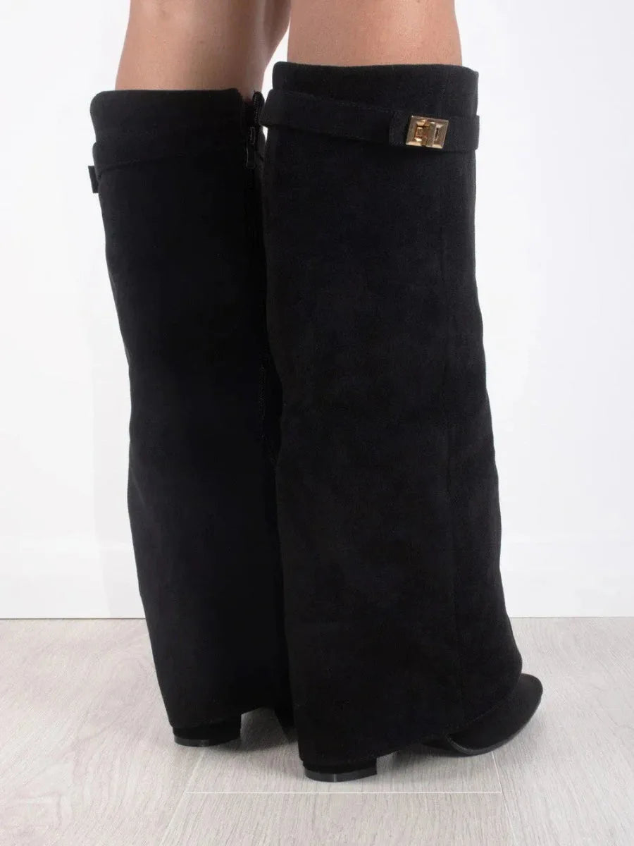 Back view of black suede fold-over boots highlighting the side zipper and gold buckle strap