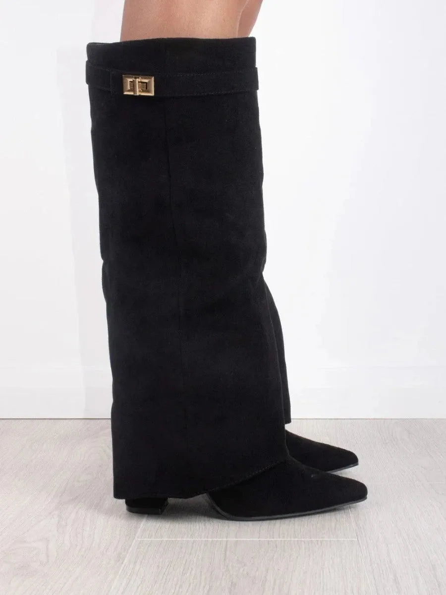 Close-up side profile of black suede boot cuff with gold turn-lock buckle detail