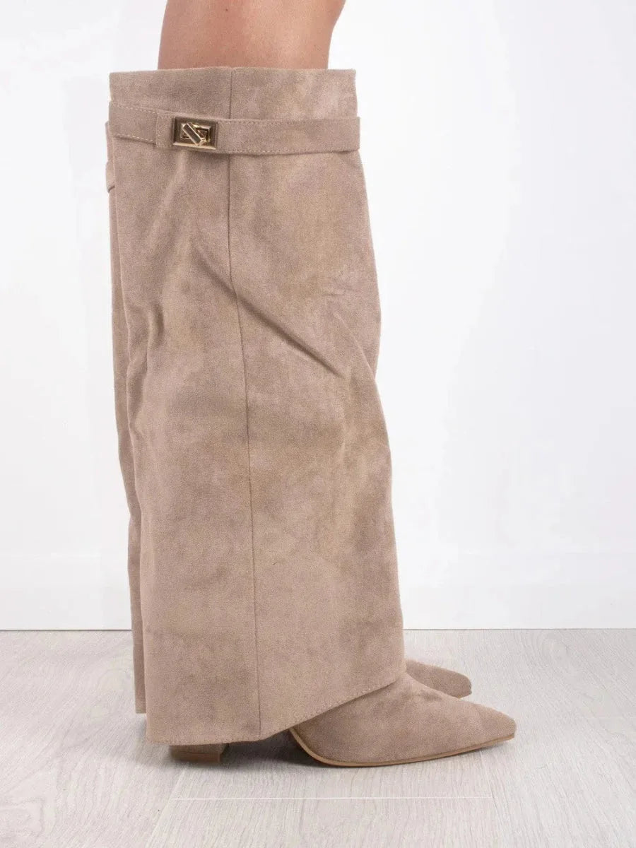 Front view of beige suede fold-over boots on both legs showing the folded cuff and gold buckle