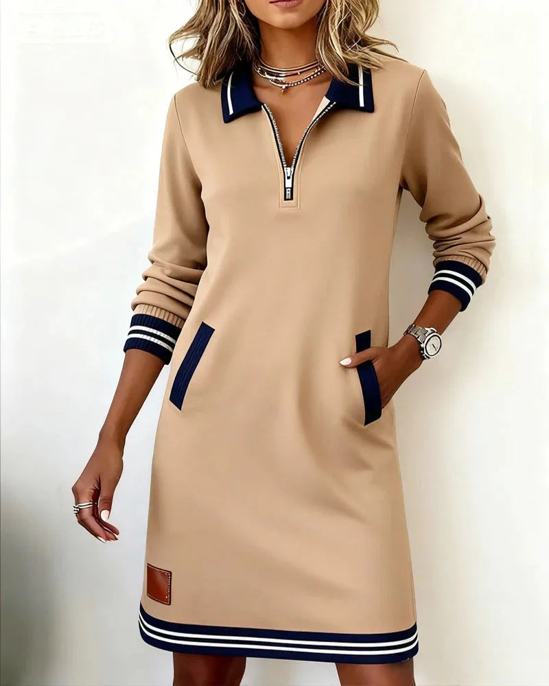 Close-up of the quarter-zip polo collar in navy and white rib knit on a grey sweatshirt dress