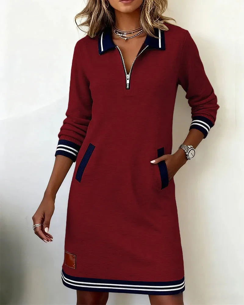 Black sweatshirt dress shown with the zip pulled partway down the polo collar neckline