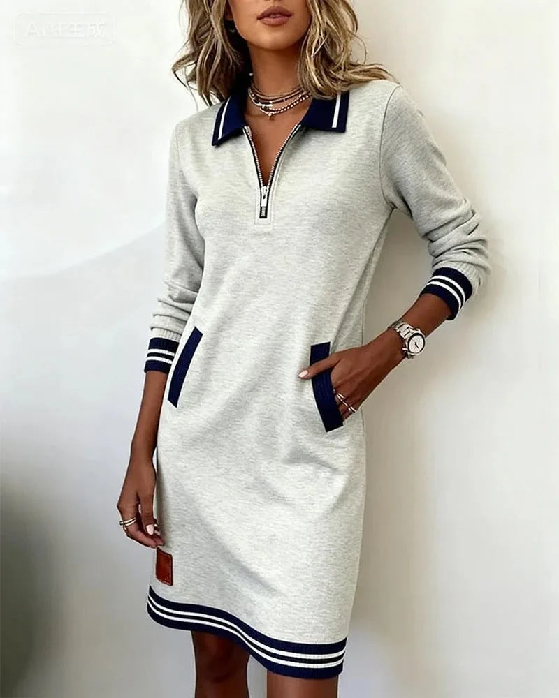 Red sweatshirt dress detail showing the striped hem band and ribbed cuff stitching