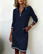 Navy sweatshirt dress close-up of the collar and zip hardware against the ribbed trim
