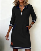 Navy blue sweatshirt dress with contrast white striped cuffs and welt pockets, worn with a silver watch