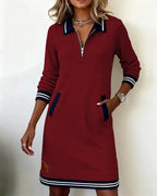 Black sweatshirt dress with polo collar, zip front and striped cuff and hem trim, shown on a model from the front