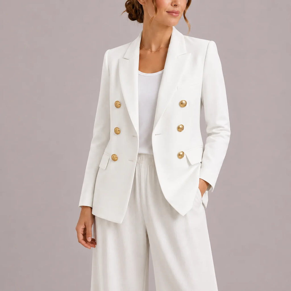 White double-breasted blazer with gold buttons, worn open with hand in pocket