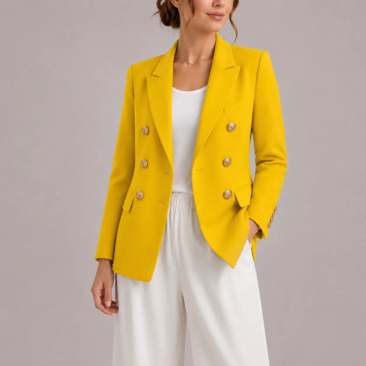Yellow double-breasted blazer with gold buttons, front detail of button placket and sleeve cuff