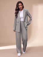 Model wearing a light grey double-breasted blazer and wide-leg trousers over a white top